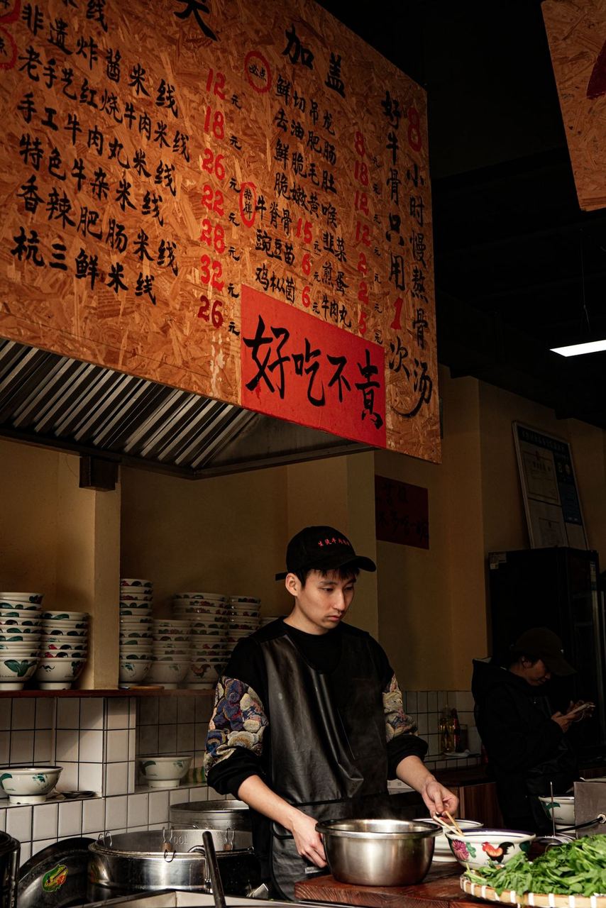 A street food stall with its menu painted in Chinese characters