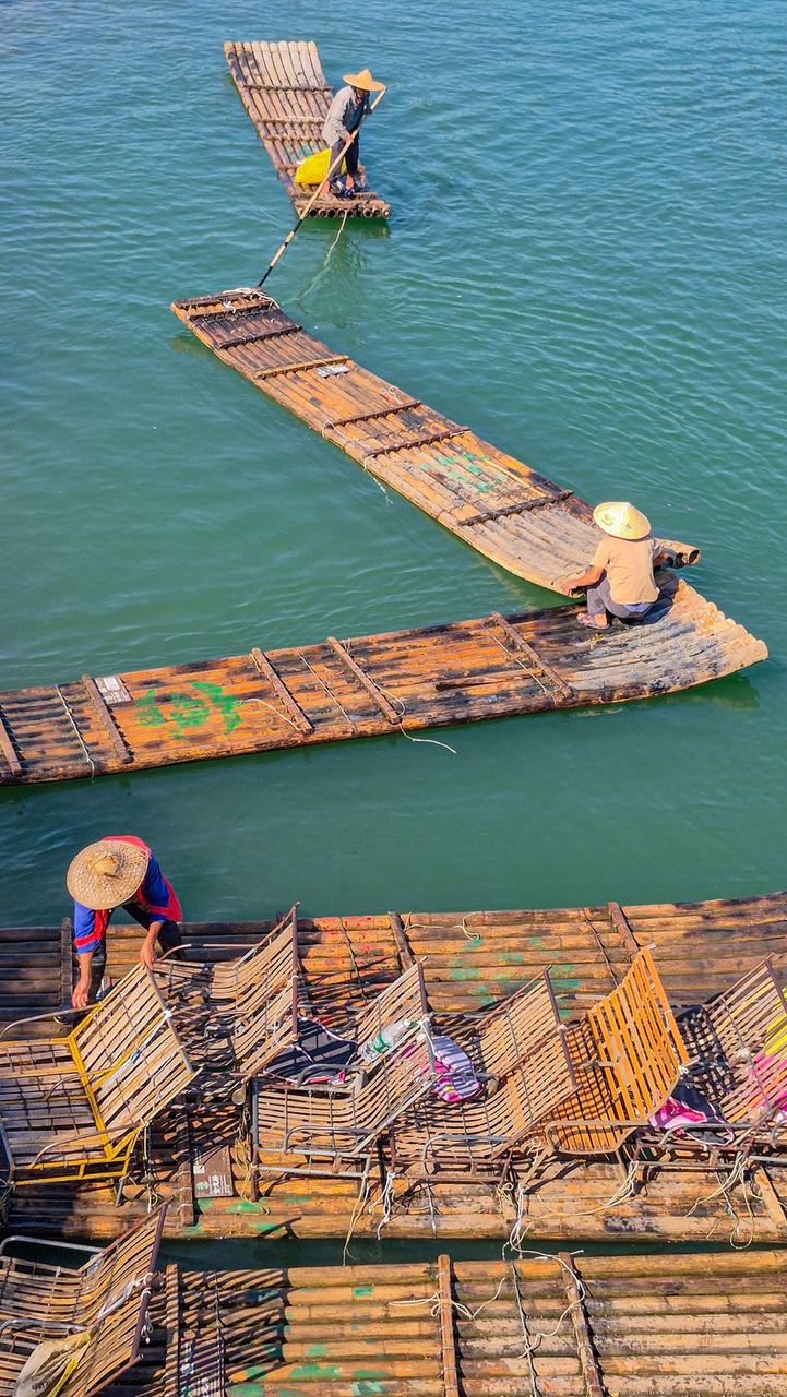 A bamboo raft on the Yulong River, poled by a boatman