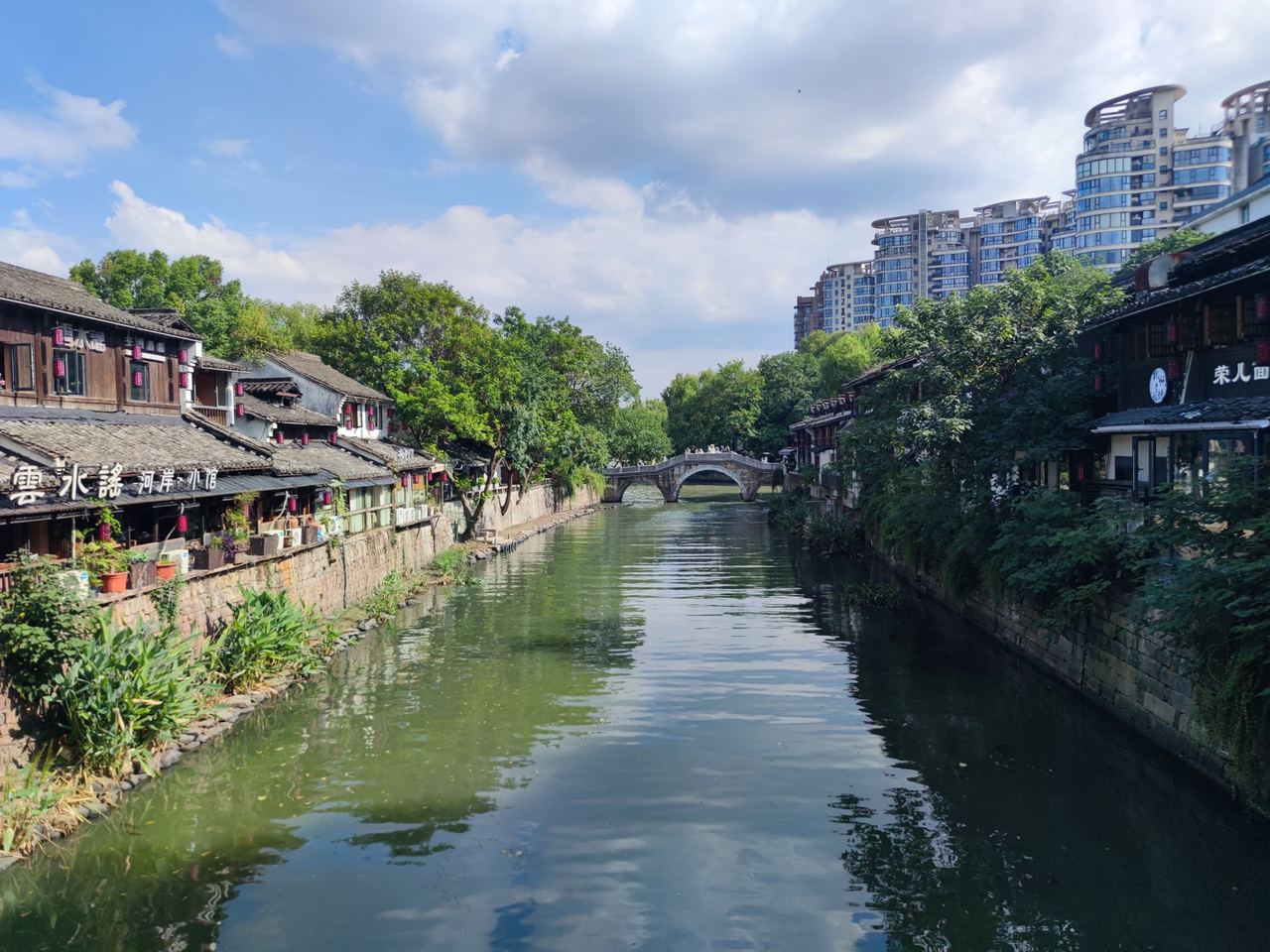 Canal-side houses and a stone arch bridge on the Grand Canal at Hangzhou