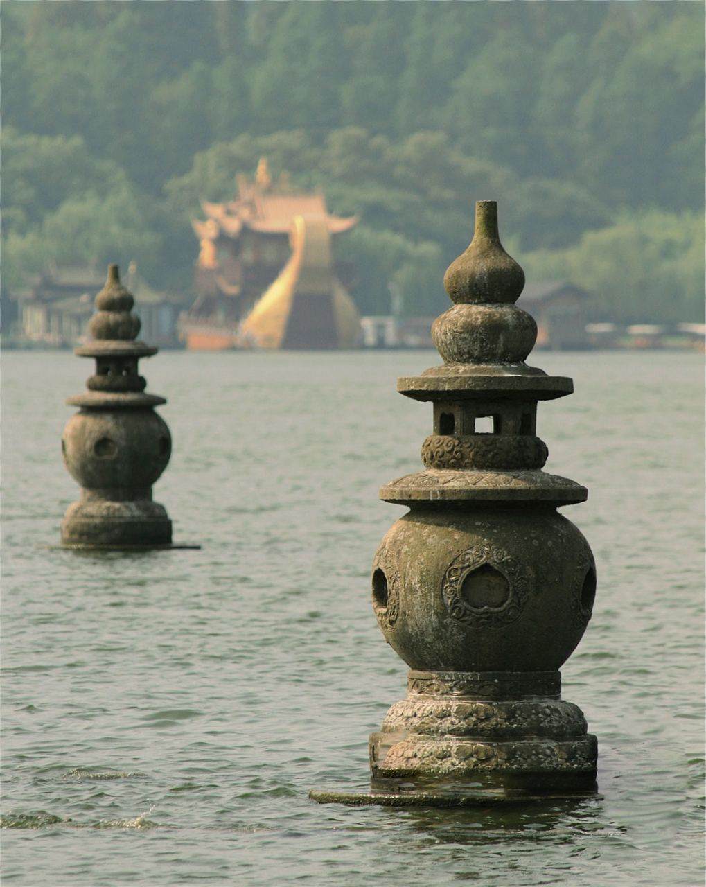 The three stone pagodas of Three Pools Mirroring the Moon, standing in the lake