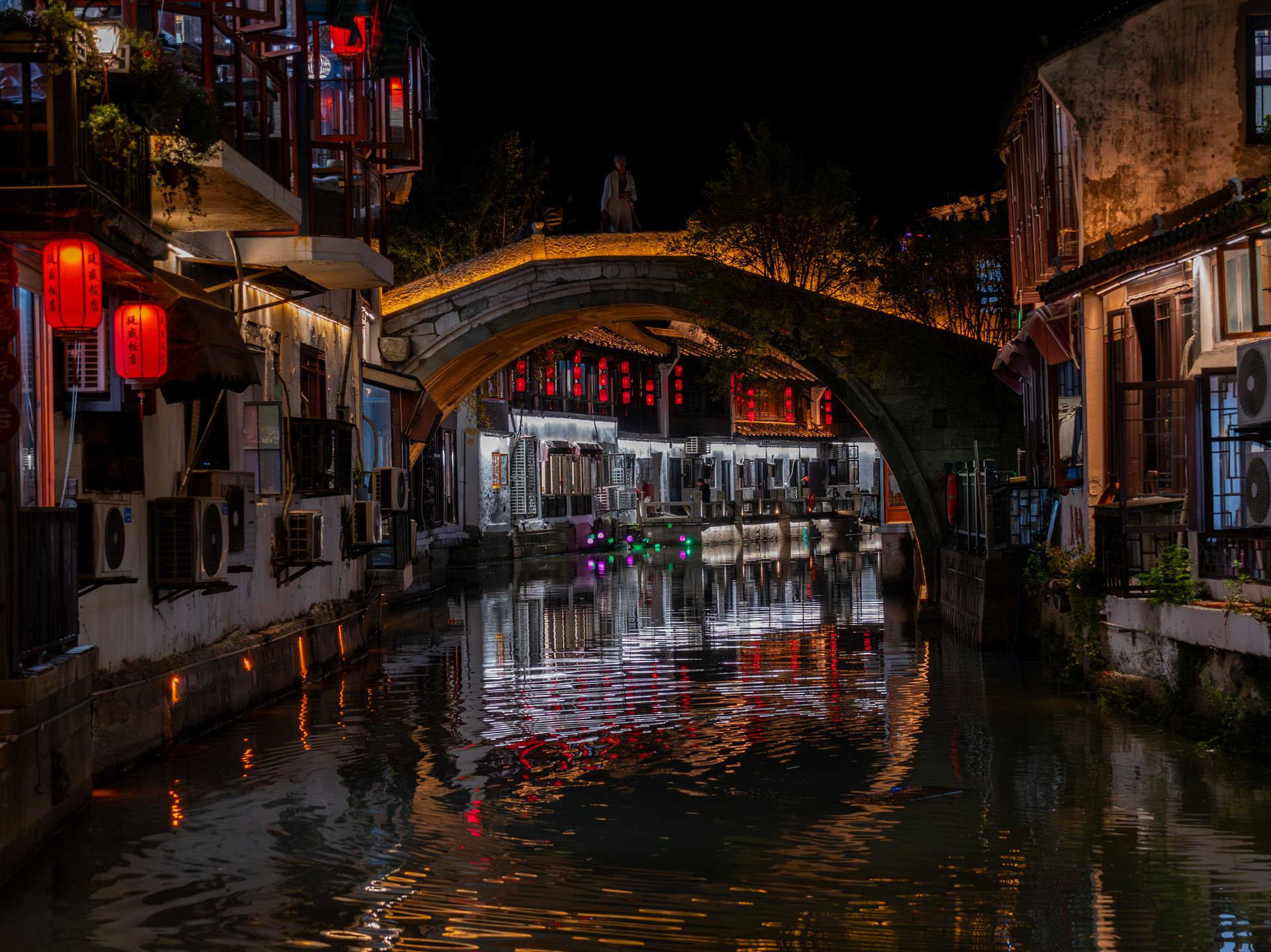 Illuminated canal and bridge on Shantang Street at night