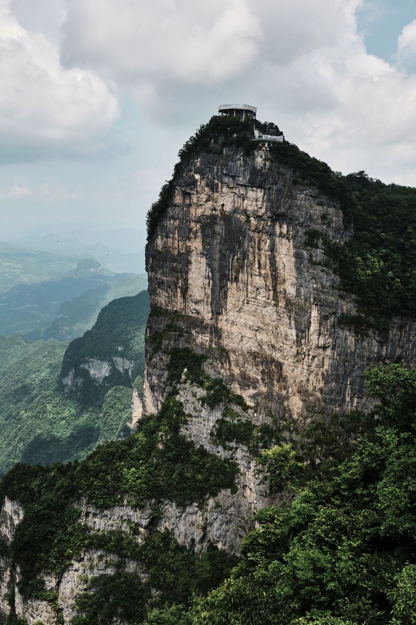 A building on the cliff-top, seen from the valley