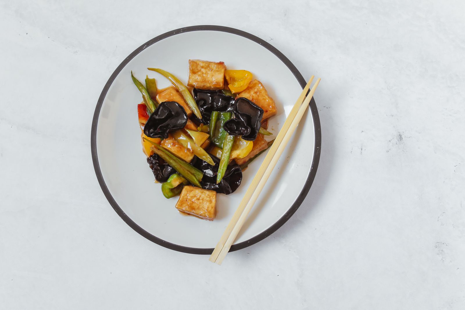 A plate of vegetarian Chinese dishes with tofu and vegetables